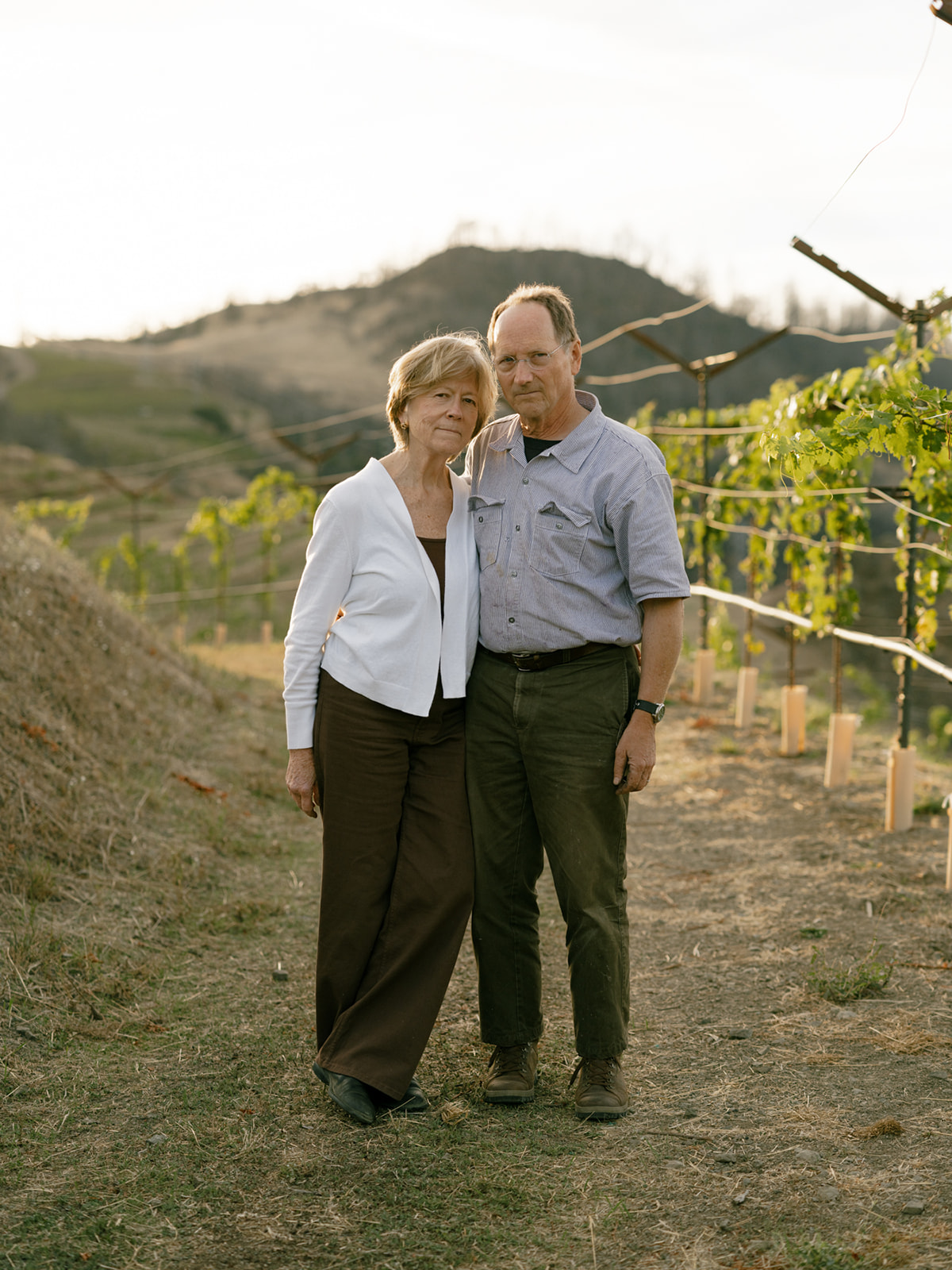 Katie Lazar and Chris Howell in the Cain Vineyard, regrowing after the Glass Fire. Photo by Meg Smith, courtesy of Club Oenologique.