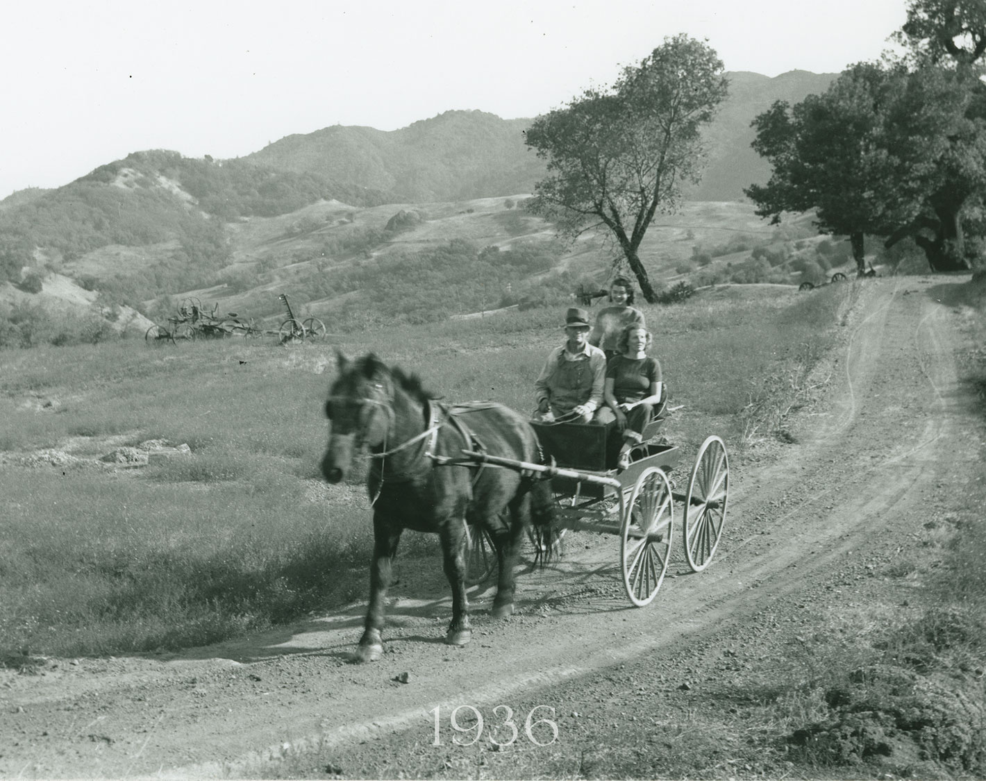 Babe, standing behind her dad, John McCormick, with friend, c.1936. La Piedra, heart of today’s Cain Vineyard, thrusts out of the hillside in the background